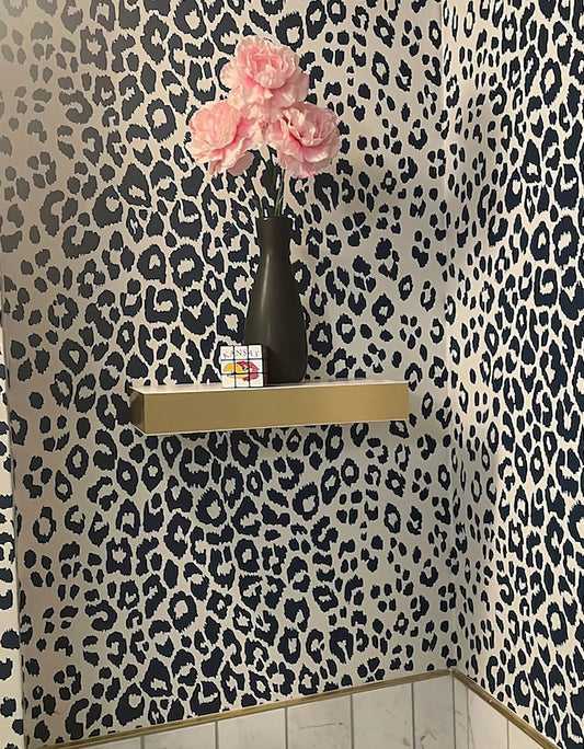 White floating shelf with stainless or brass edges, modern wall-mounted shelf for minimalist home decor.