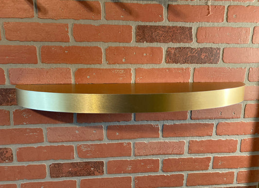 Curved gold floating shelf with oval design, stainless steel wall-mounted shelf for modern home decor.